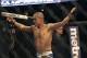 Chris Cariaso celebrates after beating Josh Ferguson in a UFC on Fuel 4 Mixed Martial Arts flyweight bout in San Jose, Calif., Wednesday, July 11, 2012. (AP Photo/Jeff Chiu)