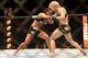Jul 16, 2014; Atlantic City, NJ, USA; Claudia Gadelha (red gloves) exchanges punches with Tina Lahdemaki (blue gloves) during a 115-pound women's division bout at Revel Casino. Mandatory Credit: Bill Streicher-USA TODAY Sports