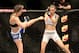 Jul 16, 2014; Atlantic City, NJ, USA; Jessamyn Duke (red gloves) blocks a kick by Leslie Smith (blue gloves) during a women's bantamweight bout at Revel Casino. Mandatory Credit: Bill Streicher-USA TODAY Sports
