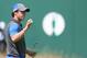 Rory McIlroy of Northern Ireland holds up his ball on the 18th green after his round on the first day of the British Open Golf championship at the Royal Liverpool golf club, Hoylake, England, Thursday July 17, 2014. (AP Photo/Peter Morrison)