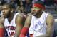 Detroit Pistons guard Brandon Jennings, from left, center Greg Monroe and forward Josh Smith watch their game against the Brooklyn Nets from the bench during the second half of an NBA basketball game Friday, Feb. 7, 2014, in Auburn Hills, Mich. (AP Photo/Duane Burleson)