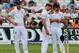England's Stuart Broad, left, James Anderson and Alastair Cook, right, confer during day five of the first Test between England and India at Trent Bridge cricket ground, Nottingham, England, Sunday, July 13, 2014. (AP Photo/Rui Vieira)