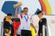 Germany's Philipp Lahm lifts the trophy at the the arrival of the German national soccer team from Brazil at Tegel airport in Berlin, Tuesday July 15, 2014. Germany beat Argentina 1-0 on Sunday to win its fourth World Cup title. (AP Photo/ Karina Hessland,pool)