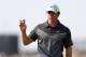 Rory McIlroy of Northern Ireland holds up his ball after playing a birdie on the 8th green during the second day of the British Open Golf championship at the Royal Liverpool golf club, Hoylake, England, Friday July 18, 2014. (AP Photo/Scott Heppell)