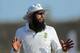 South Africa's test cricket captain Hashim Amla gestures to a teammate during the second day of the first test cricket match between Sri Lanka and South Africa in Galle, Sri Lanka, Thursday, July 17, 2014. (AP Photo/Eranga Jayawardena)