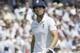 England's captain Alastair Cook leaves the field after being caught by M S Dhoni off the bowling of India's Bhuvneshwar Kumar during the second day of the second test match between England and India at Lord's cricket ground in London, Friday, July 18, 2014. (AP Photo/Kirsty Wigglesworth)