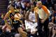 West's Skylar Diggins (4), of the Tulsa Shock, pushes the ball up court as East's Tamika Catchings (24), of the Indiana Fever, looks on during the first half the WNBA All-Star basketball game, Saturday, July 19, 2014, in Phoenix. (AP Photo/Matt York)