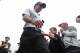 Rory McIlroy of Northern Ireland shakes hands with a young fan as he walks to the 18th tee box during the third day of the British Open Golf championship at the Royal Liverpool golf club, Hoylake, England, Saturday July 19, 2014. (AP Photo/Jon Super)
