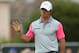 Rory McIlroy of Northern Ireland waves to the crowd after playing a birdie on the 1st hole during the final round of the British Open Golf championship at the Royal Liverpool golf club, Hoylake, England, Sunday July 20, 2014. (AP Photo/Peter Morrison)