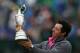 Rory McIlroy of Northern Ireland holds up the Claret Jug trophy after winning the British Open Golf championship at the Royal Liverpool golf club, Hoylake, England, Sunday July 20, 2014. (AP Photo/Scott Heppell)