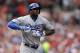 Los Angeles Dodgers' Yasiel Puig pulls a glove off his left hand as he takes his base after being hit by a pitch during the third inning of a baseball game against the St. Louis Cardinals Saturday, July 19, 2014, in St. Louis. Puig left the game in the eighth inning and the Cardinals went on to win 4-2. (AP Photo/Jeff Roberson)