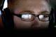 In this July 11, 2014 photo, a video screen is reflected in the glasses of Steven