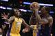 Phoenix Suns guard Eric Bledsoe, right, shoots over Los Angeles Lakers center Jordan Hill during the second half of an NBA basketball game in Los Angeles, Tuesday, Dec. 10, 2013. (AP Photo/Chris Carlson)
