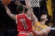 Chicago Bulls point guard Derrick Rose, left, puts up a shot against Los Angeles Lakers power forward Pau Gasol, of Spain, during the second half of their NBA basketball game in Los Angeles, Tuesday, Nov. 23, 2010. The Lakers won 98-91.(AP Photo/Jae C. Hong)
