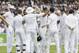 England's captain Alastair Cook, center, celebrates with his team after he catches out India's Stuart Binny for zero during the fourth day of the second test match between England and India at Lord's cricket ground in London, Sunday, July 20, 2014. (AP Photo/Kirsty Wigglesworth)