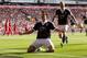 Southampton's Dejan Lovren, centre, celebrates after scoring against Liverpool during their English Premier League soccer match at Anfield Stadium, Liverpool, England, Saturday Sept. 21, 2013. (AP Photo/Jon Super)