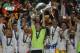 Real goalkeeper Iker Casillas, centre, lifts the Champion League trophy, as he and teammates, celebrate winning the Champion League title, against Atletico Madrid, in Lisbon, Portugal, Saturday, May 24, 2014. (AP Photo/Andres Kudacki)