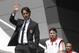 AC Milan coach Filippo Inzaghi waves during the presentation of the upcoming 2014-15 season at the AC Milan headquarter in Milan, Italy, Thursday, July 10, 2014. In background are midfielder Riccardo Montolivo and forward Giampaolo Pazzini. (AP Photo/Luca Bruno)