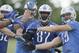 Detroit Lions tight end Brandon Pettigrew catches a ball through the distraction of teammates during an NFL football minicamp in Allen Park, Mich., Wednesday, June 11, 2014. (AP Photo/Carlos Osorio)