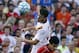 AS Roma midfielder Alessandro Florenzi (24) goes up for the ball against Liverpool FC midfielder Philippe Coutinho, below, during a friendly soccer match at Fenway Park in Boston, Wednesday, July 23, 2014. (AP Photo)