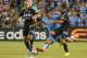 Aleks Kolarov forces his way between Aurelien Collin and Benny Feilhaber.