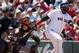 Boston Red Sox's David Ortiz, right, follows through on a double in front of Baltimore Orioles' Caleb Joseph in the fourth inning of a baseball game in Boston, Sunday, July 6, 2014. (AP Photo/Michael Dwyer)