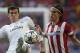 Atletico's Filipe Luis, right, fights for the ball with Real's Gareth Bale during the Champions League final soccer match between Atletico Madrid and Real Madrid in Lisbon, Portugal, Saturday, May 24, 2014. (AP Photo/Andres Kudacki)