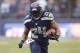 Seattle Seahawks' Marshawn Lynch rushes against the Arizona Cardinals in the first half of an NFL football game, Sunday, Dec. 22, 2013, in Seattle. (AP Photo/Stephen Brashear)