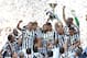 Juventus' players and staff celebrate at the end of a Serie A soccer match between Juventus and Cagliari at the Juventus Stadium in Turin, Italy, Sunday, May 18, 2014. Juventus celebrated its third straight Serie A title with a 3-0 home victory over Cagliari to set a new European record of 102 points. Antonio Conte's side had already broken the Serie A points record but ensured it moved into triple figures by also becoming the first Italian side to maintain a 100% home record.(AP Photo/Massimo Pinca)