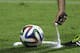 A referee uses vanishing spray during a referee's training session in Rio de Janeiro, Brazil, Friday, June 6, 2014. Referees will use vanishing spray during 2014 World Cup to stop defensive walls creeping forward at free-kicks. The international soccer tournament is set to begin in a few days, with Brazil and Croatia competing in the opening match on June 12. (AP Photo/Hassan Ammar)