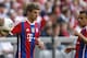 Bayern's Thomas Mueller, left, lifts a ball besides his teammate Bayern's Rafinha of Brazil during the German first division Bundesliga soccer match between FC Bayern Munich and VfB Stuttgart, in Munich, southern Germany, Saturday, May 10, 2014. (AP Photo/Matthias Schrader)