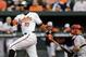 Baltimore Orioles' Adam Jones watches his solo home run in front of Los Angeles Angels catcher Hank Conger in the first inning of a baseball game, Tuesday, July 29, 2014, in Baltimore. (AP Photo/Patrick Semansky)