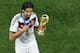 Germany's Sami Khedira points at the trophy after winning the World Cup final soccer match between Germany and Argentina at the Maracana Stadium in Rio de Janeiro, Brazil, Sunday, July 13, 2014. Mario Goetze volleyed in the winning goal in extra time to give Germany its fourth World Cup title with a 1-0 victory over Argentina on Sunday. (AP Photo/Fabrizio Bensch, Pool)
