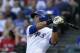Texas Rangers' Alex Rios follows through on a swing against the Houston Astros in a baseball game, Tuesday, July 8, 2014, in Arlington, Texas. (AP Photo/Tony Gutierrez)