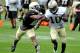 New Orleans Saints wide receiver Brandin Cooks (10) pushes off New Orleans Saints cornerback Patrick Robinson (21) during there NFL football training camp inWhite Sulphur Springs , W. Va., Sunday, July 27, 2014. (AP Photo/Chris Tilley)