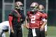 San Francisco 49ers quarterbacks Colin Kaepernick (7) and Blaine Gabbert (2) walk on the practice field during NFL football mini-camp in Santa Clara, Calif., Wednesday, June 18, 2014. (AP Photo/Jeff Chiu)