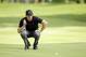 Rory McIlroy looks over a putt on the 11th green during the first round of the Bridgestone Invitational golf tournament Thursday, July 31, 2014, at Firestone Country Club in Akron, Ohio. (AP Photo/Mark Duncan)