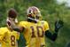 Washington Redskins quarterback Robert Griffin III prepares to throw during practice at the team's NFL football training facility, Sunday, July 27, 2014 in Richmond, Va. (AP Photo/Alex Brandon)
