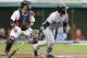 Seattle Mariners' Robinson Cano, right, watches his ball after hitting an RBI-double off Cleveland Indians starting pitcher Zach McAllister in the third inning of a baseball game Thursday, July 31, 2014, in Cleveland. Chris Taylor scored on the play. Indians catcher Yan Gomes watches (AP Photo/Tony Dejak)