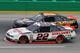 Pole-sitter Brad Keselowski (22) passes the lapped car of Jamie Dick during the NASCAR Nationwide series auto race at Kentucky Speedway in Sparta, Ky., Friday June 27, 2014. (AP Photo/Garry Jones)