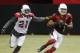 Arizona Cardinals' Larry Fitzgerald (11) makes a catch in front of Patrick Peterson (21) during NFL football training camp practice on Wednesday, July 30, 2014, in Glendale, Ariz. (AP Photo/Ross D. Franklin)