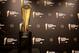 This Monday, July 14, 2014 photo shows the College Football Playoff National Championship Trophy in Irving, Texas. A rising gold football-shaped trophy will be the prize for the national champion in the new College Football Playoff. (AP Photo/Tony Gutierrez)