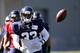 Seattle Seahawks' Christine Michael tosses aside a ball at an NFL football camp practice Sunday, July 27, 2014, in Renton, Wash. (AP Photo/Elaine Thompson)