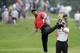 Tiger Woods makes an awkward follow through after hitting from the lip of a fairway bunker on the second hole during the final round of the Bridgestone Invitational golf tournament Sunday, Aug. 3, 2014, at Firestone Country Club in Akron, Ohio. (AP Photo/Mark Duncan)