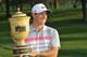 Rory McIlroy poses with the championship trophy after winning the Bridgestone Invitational golf tournament, Sunday, Aug. 3, 2014, in Akron, Ohio. McIlroy won with a final round 66 to beat Sergio Garcia by two strokes. (AP Photo/Phil Long)