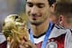 Germany's Mats Hummels holds the trophy after the World Cup final soccer match between Germany and Argentina at the Maracana Stadium in Rio de Janeiro, Brazil, Sunday, July 13, 2014. Germany won the match 1-0. (AP Photo/Matthias Schrader)