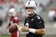 Arizona Cardinals' Carson Palmer flips the ball back to the center after he takes a snap during the first day of NFL football training camp on Saturday, July 26, 2014, in Glendale, Ariz. (AP Photo/Ross D. Franklin)