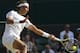 Rafael Nadal of Spain plays a return to Nick Kyrgios of Australia during their men's singles match on Centre Court at the All England Lawn Tennis Championships in Wimbledon, London, Tuesday, July 1, 2014. (AP Photo/Ben Curtis)