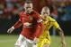 Manchester United forward Wayne Rooney, left, runs with the ball as Liverpool defender Martin Skrtel, right, defends in the second half during the final of the Guinness International Champions Cup soccer match, Monday, Aug. 4, 2014, in Miami Gardens, Fla. Manchester United defeated Liverpool 3-1. (AP Photo/Lynne Sladky)