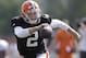 Cleveland Browns quarterback Johnny Manziel runs during practice at the NFL football team's training camp Monday, Aug. 4, 2014, in Berea, Ohio. Manziel has taken his first snaps in training camp with Cleveland's starters. Manziel is trying to beat out Brian Hoyer for the starting job. The former Heisman Trophy winner from Texas A&M had worked exclusively with Cleveland's second-string offense until Monday. (AP Photo/Tony Dejak)